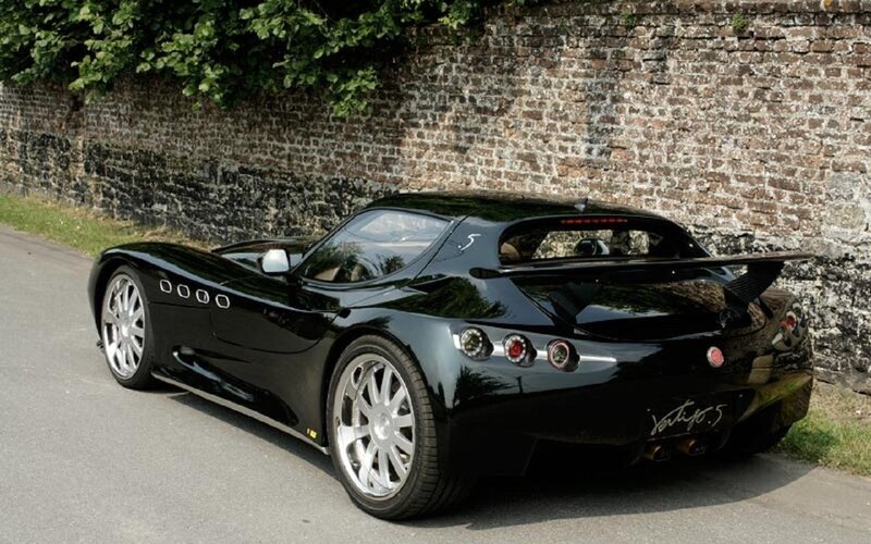 Black Sports Car — Calm, Afternoon, Photograph, Brick Wall