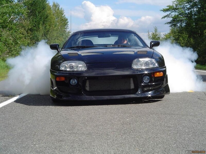 Black sports car doing burnout