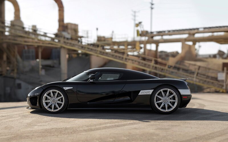 Black Sports Car — Dramatic, Afternoon, Photograph, Industrial Structures, Concrete Ground