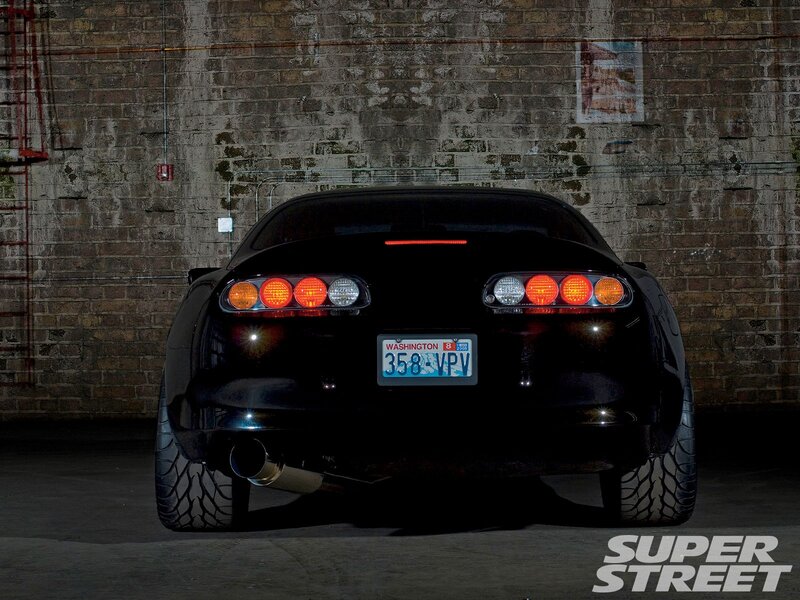 Black Sports Car — Dramatic, Night, Photograph, Brick Wall