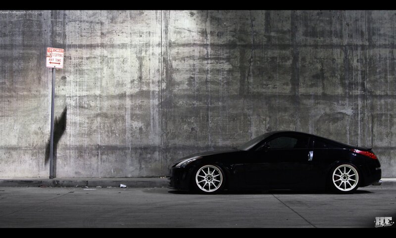 Black Sports Car — Dramatic, Night, Photograph, Concrete Wall, Sign