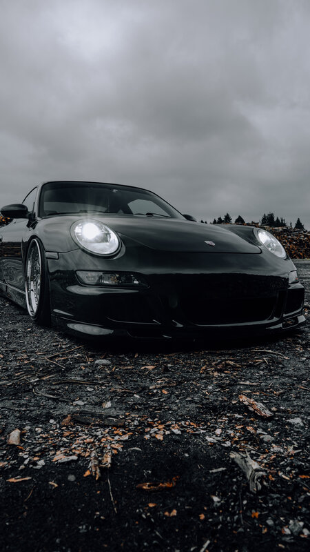 Black Sports Car — Dramatic, Photograph, Gravel