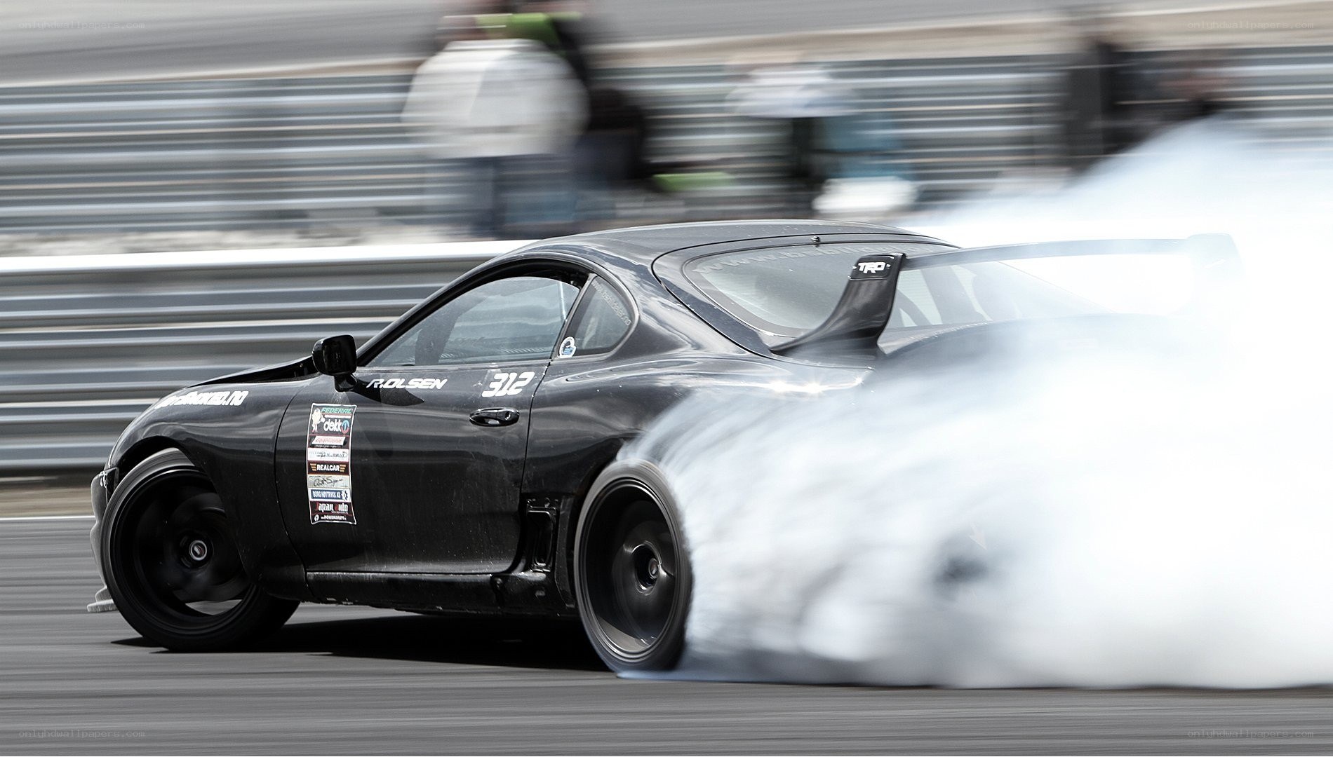 Black sports car drifting
