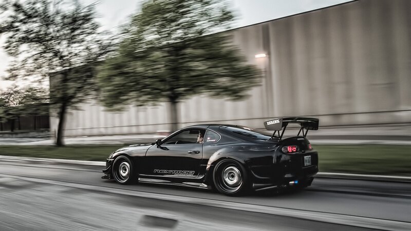 Black Sports Car — Dynamic, Afternoon, Photograph, Trees, Building