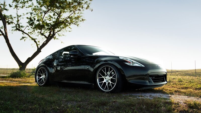 Black sports car in a field