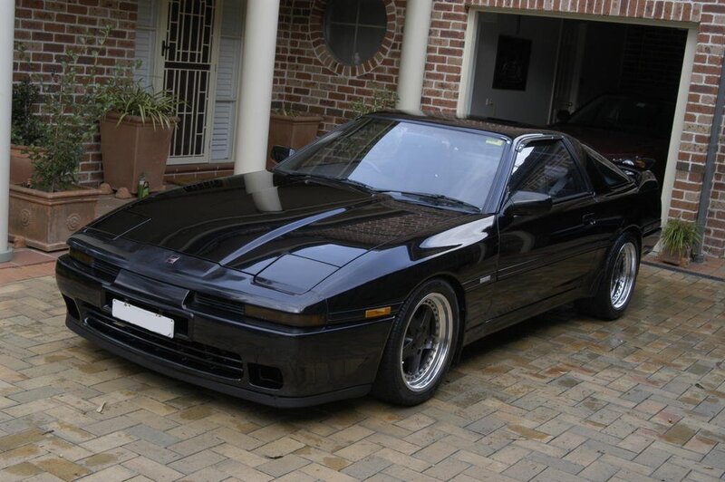 Black sports car in driveway