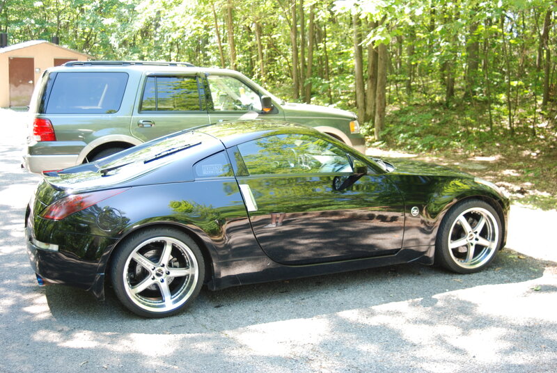 Black sports car in forest parking