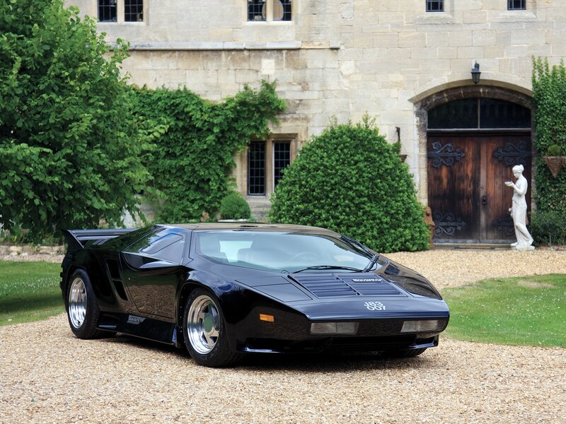 Black sports car in front of a castle
