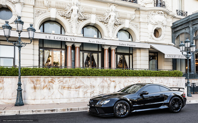 Black sports car in front of luxury hotel