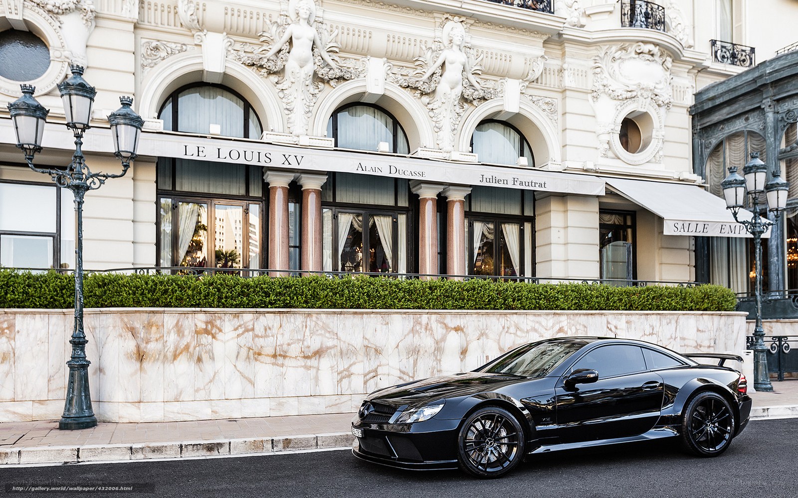 Black sports car in front of luxury hotel