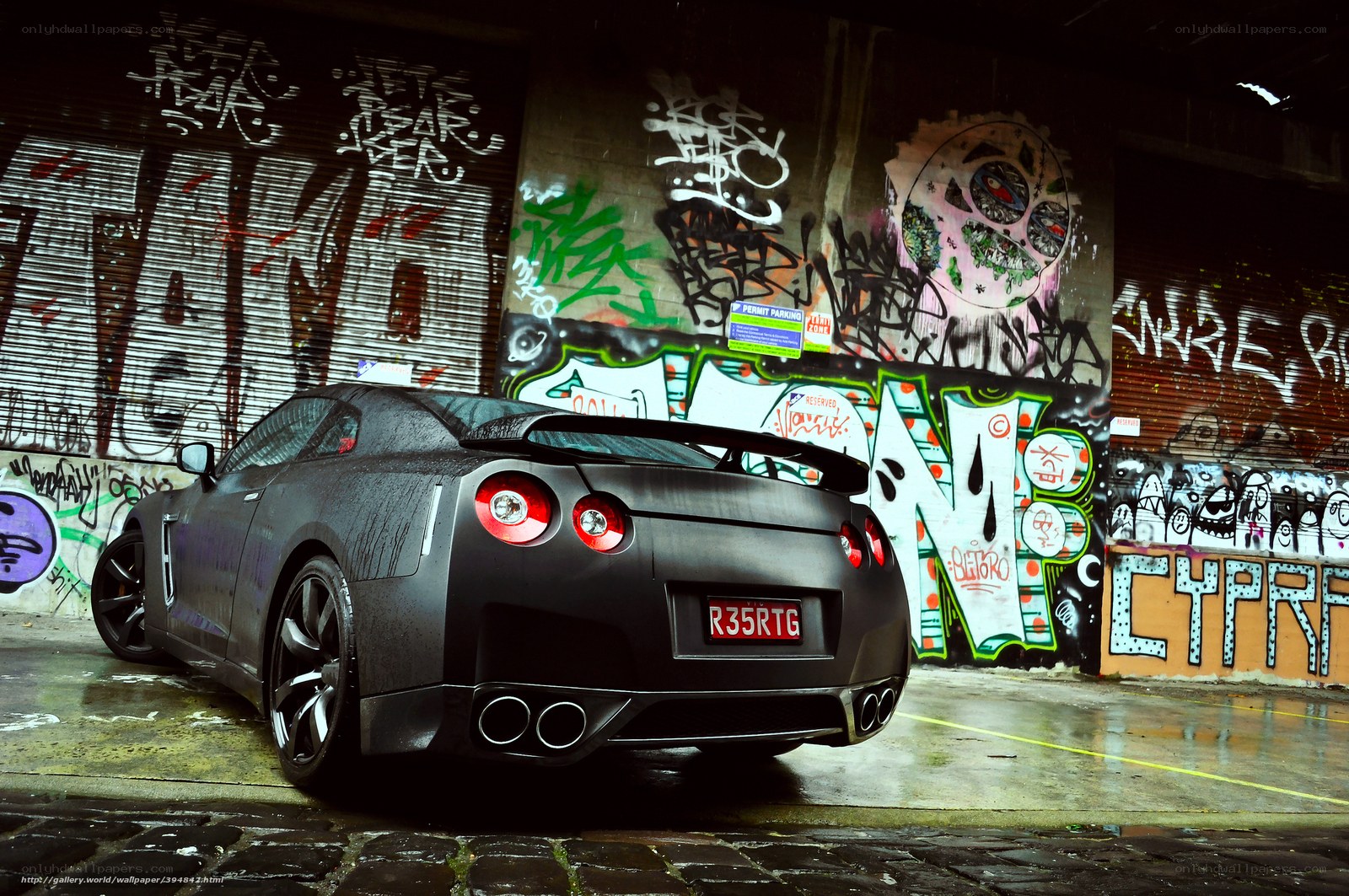Black sports car in graffiti alley