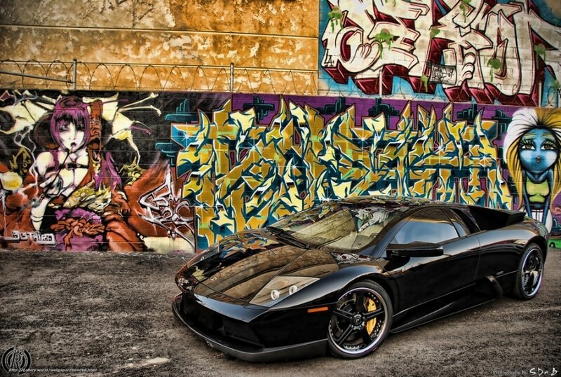 Black sports car in graffiti alley