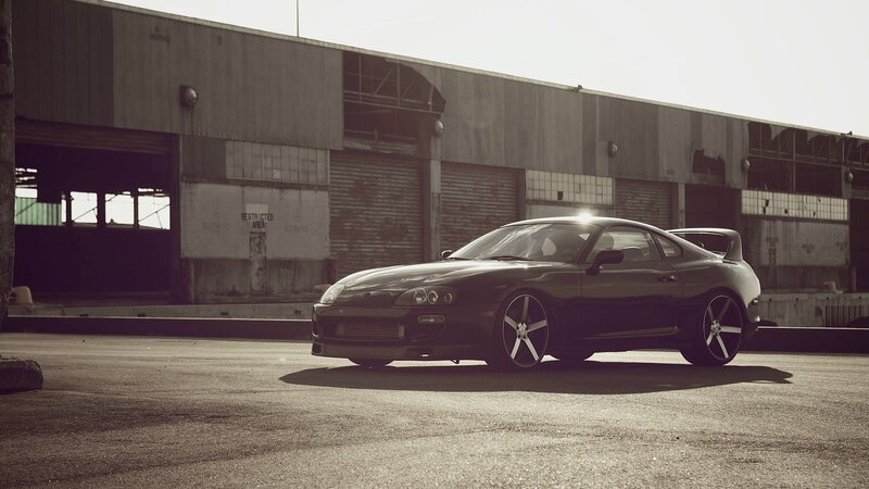 Black sports car in industrial lot