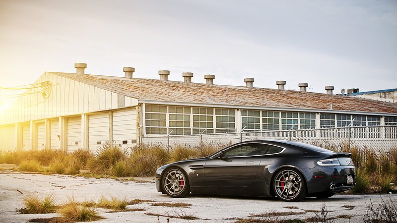 Black sports car in industrial setting