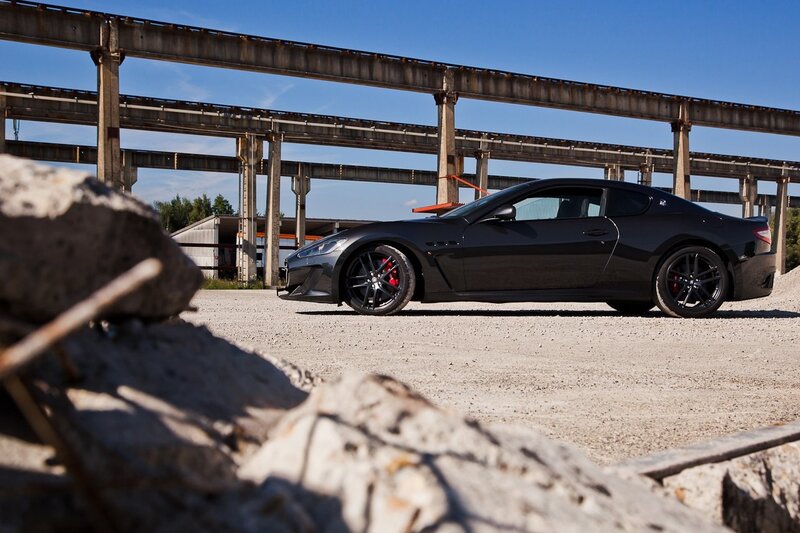 Black sports car in industrial setting