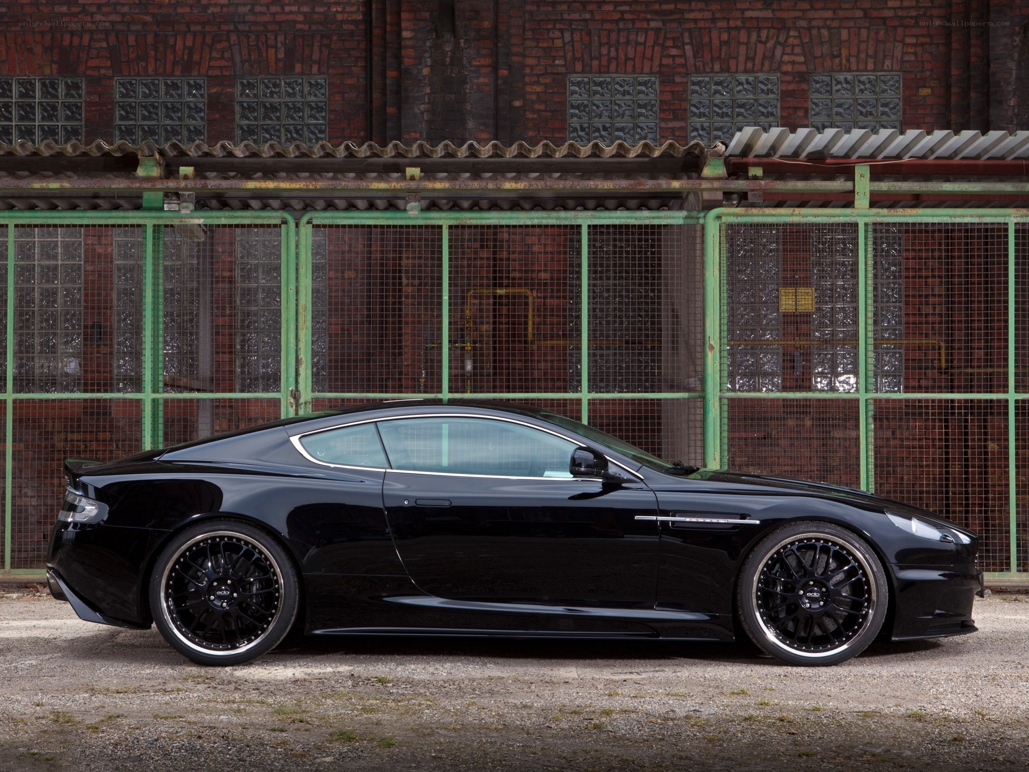 Black sports car in industrial setting