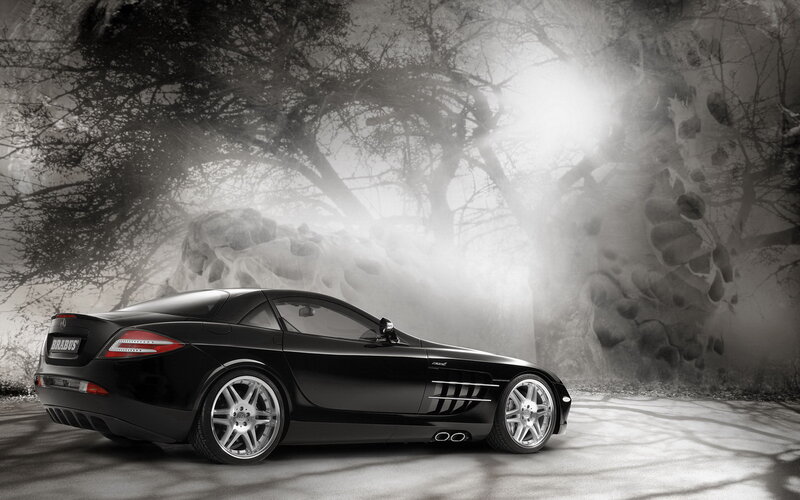 Black sports car in misty forest