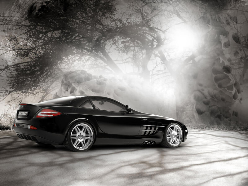 Black sports car in misty forest