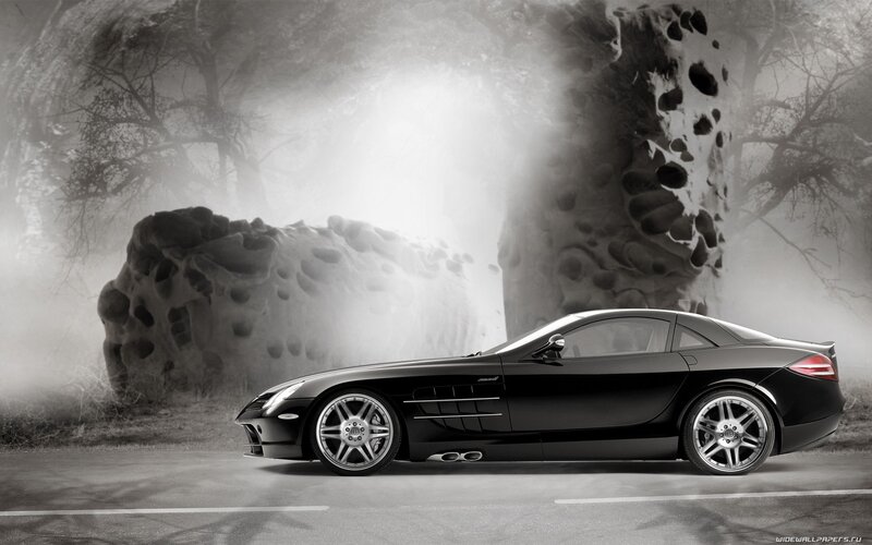 Black sports car in misty landscape