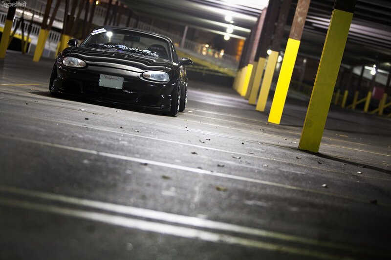 Black sports car in parking garage