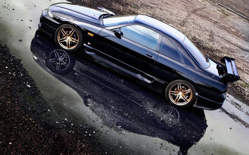 black sports car in puddle