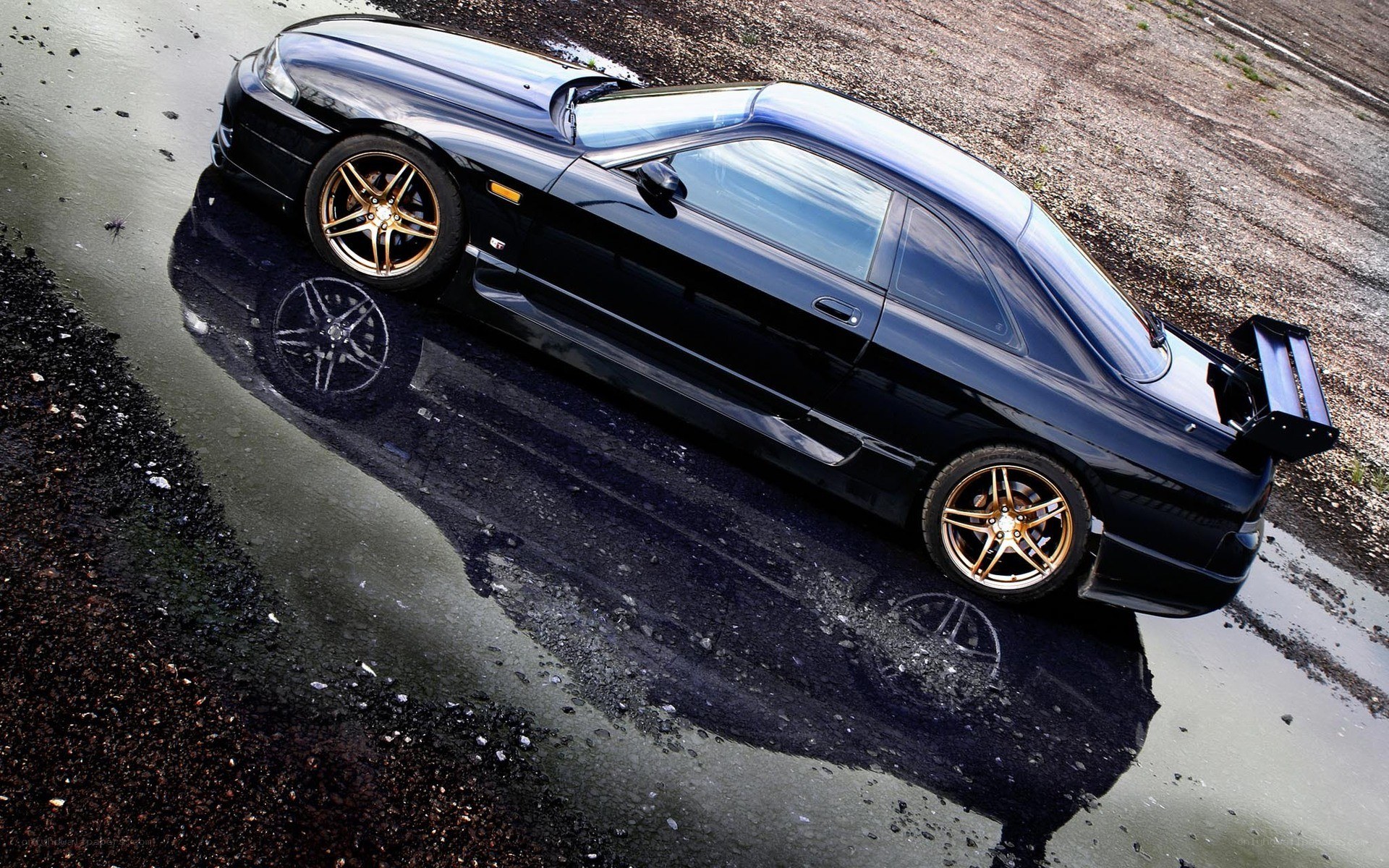 black sports car in puddle