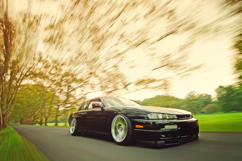 Black sports car on a country road