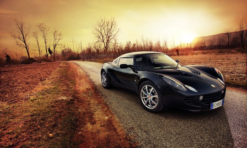 Black sports car on a country road