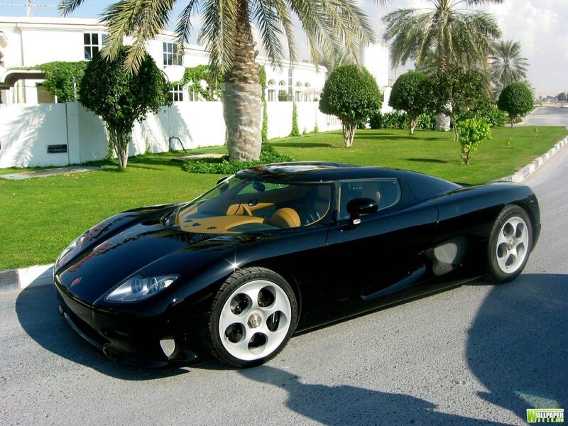 Black sports car on a driveway