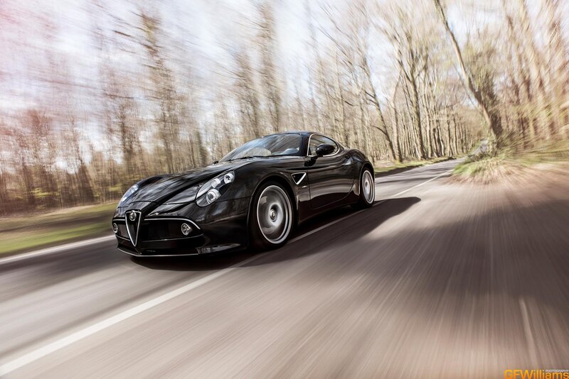 Black sports car on a forest road