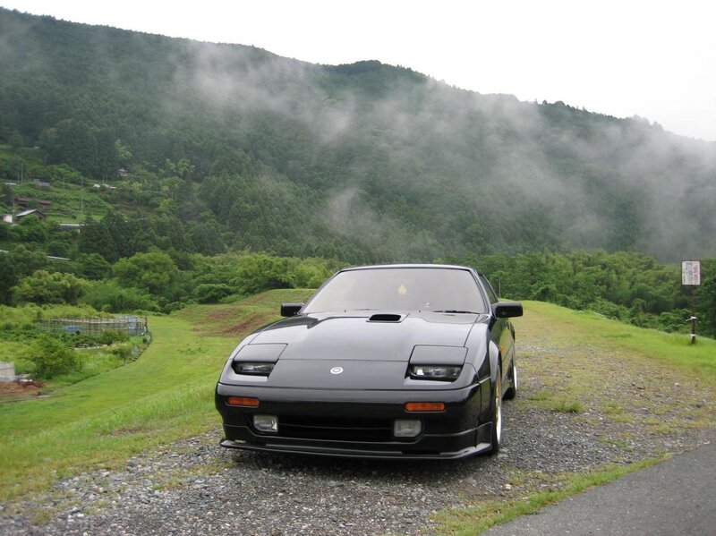 Black sports car on a misty hillside