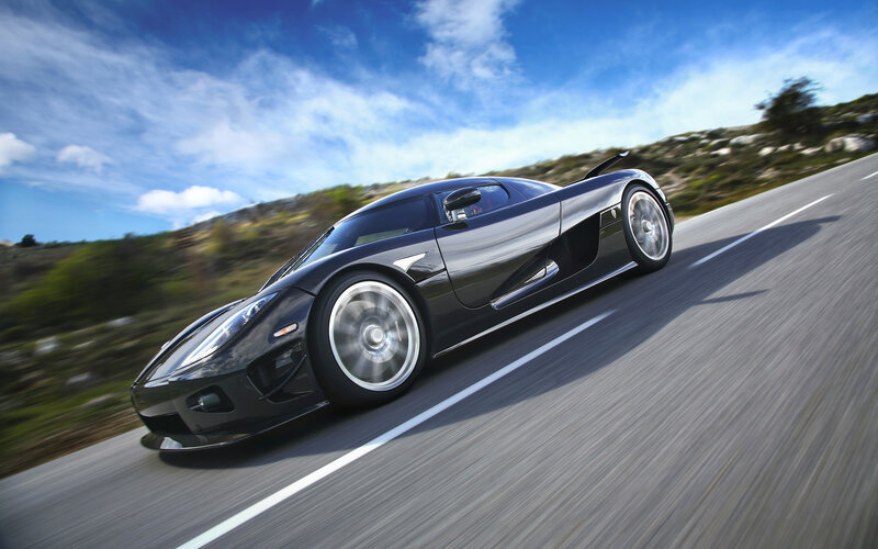 Black sports car on a road