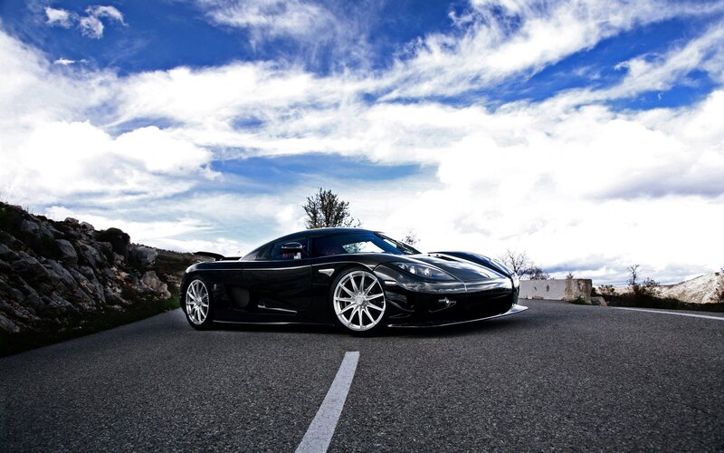 Black sports car on a road