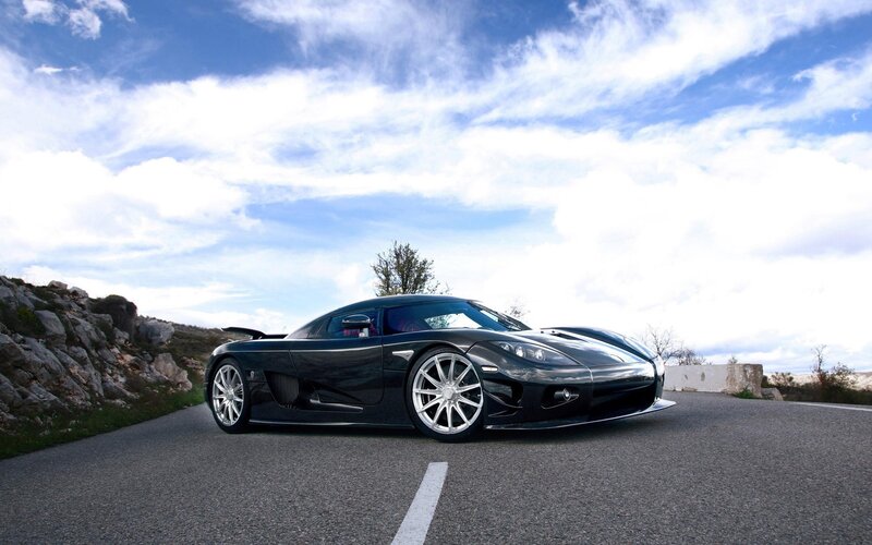 Black sports car on a road