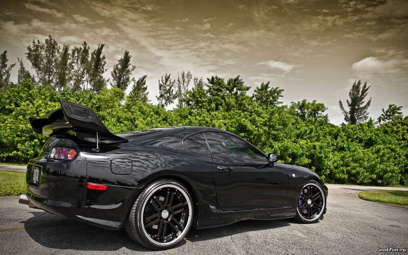 Black sports car on a road