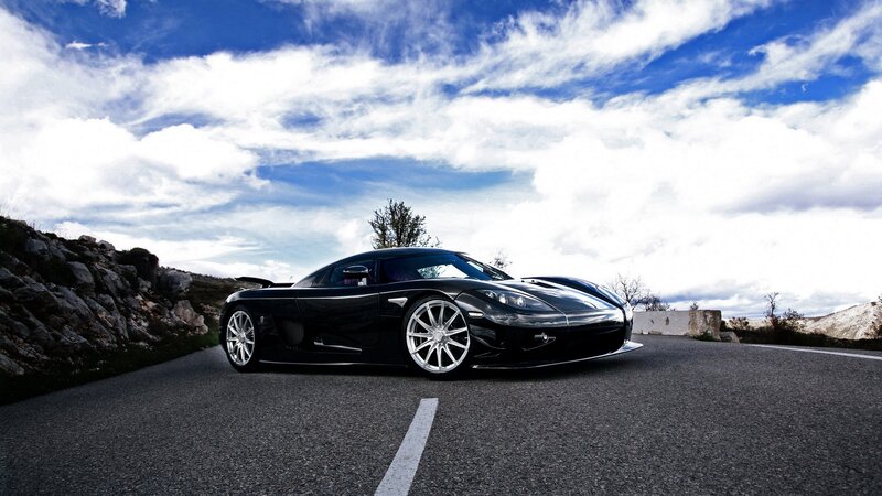Black sports car on a road