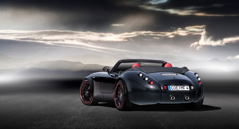 Black sports car on a road