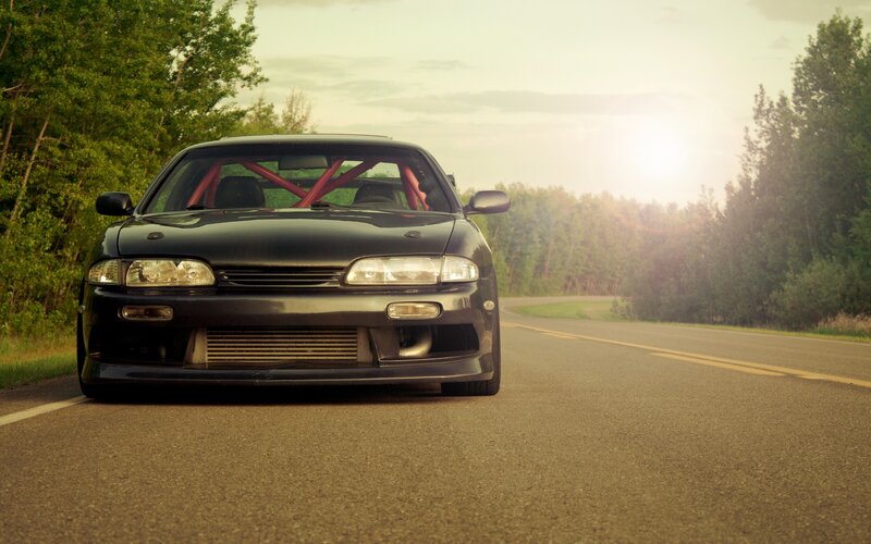 Black sports car on a road