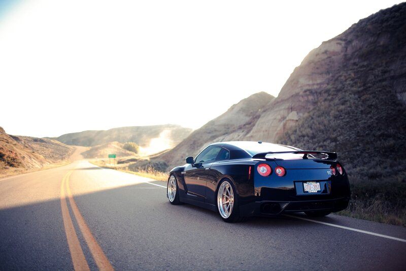 Black sports car on a winding road