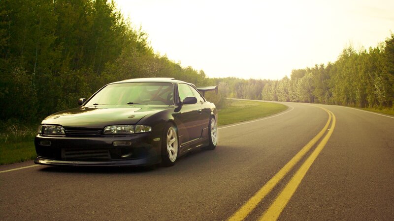 black sports car on a winding road