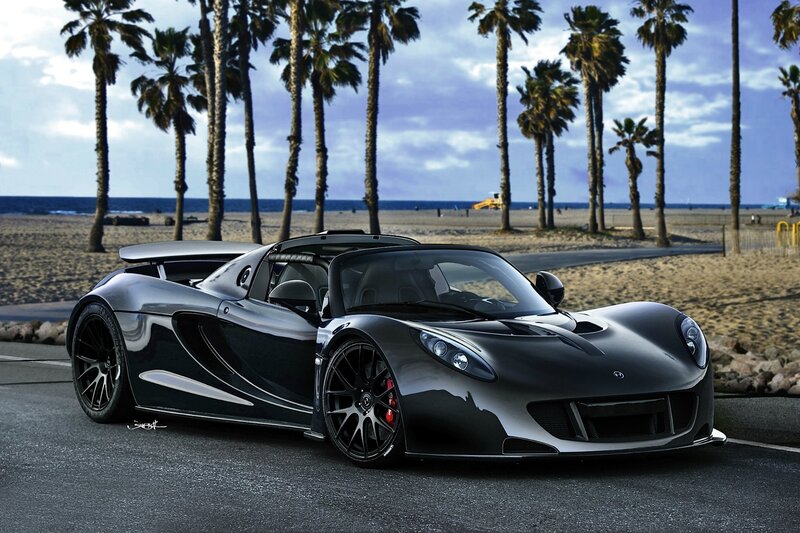 Black sports car on beach road