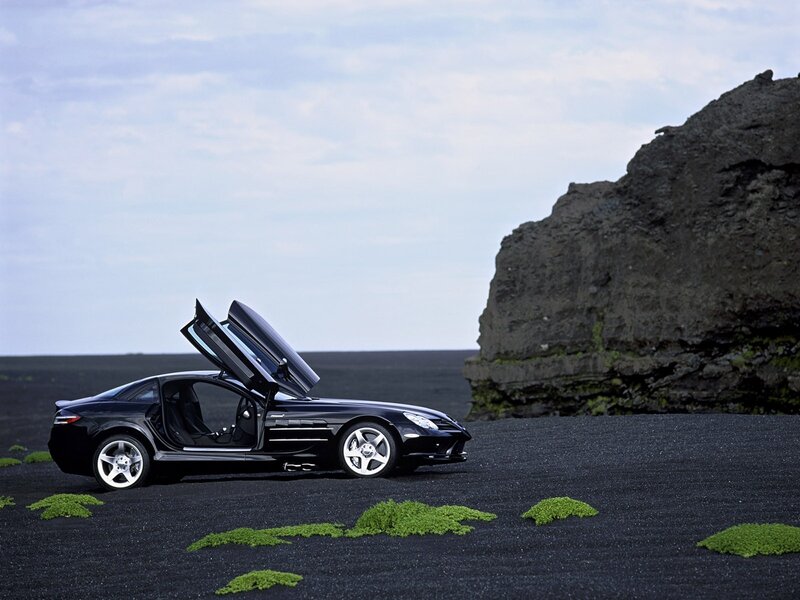 Black sports car on black sand