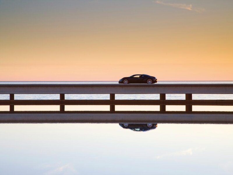 Black Sports Car on Bridge — Orange