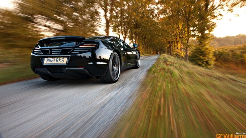 Black sports car on country road