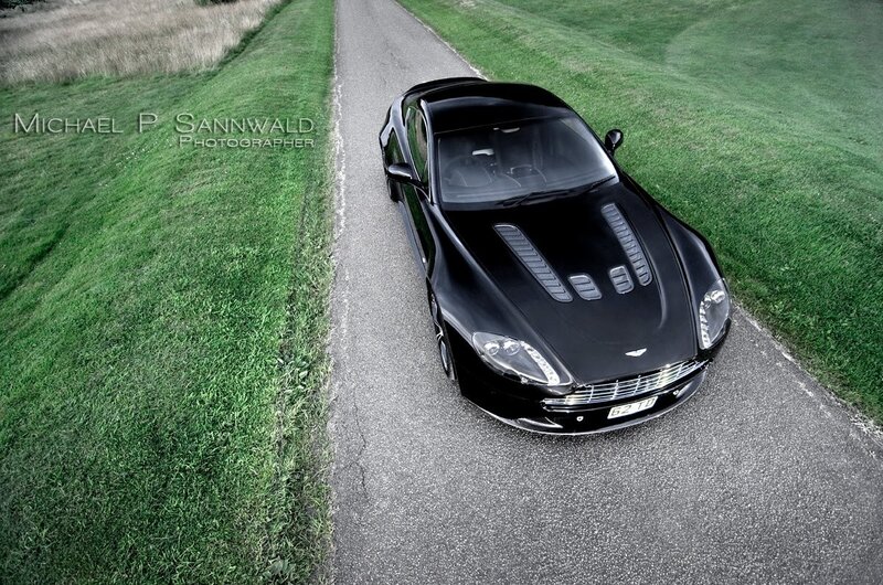 Black sports car on country road