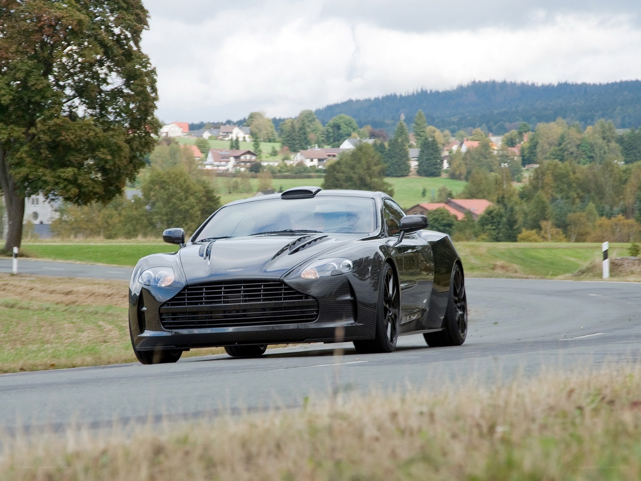 Black sports car on country road