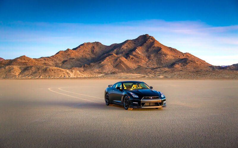 Black sports car on desert plain