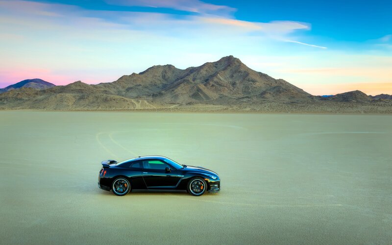 Black sports car on desert plain