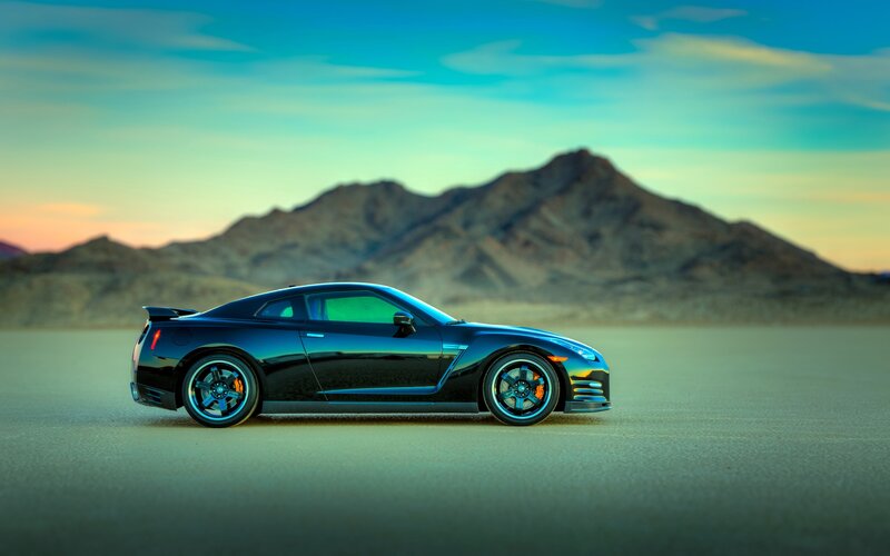 Black sports car on desert plain