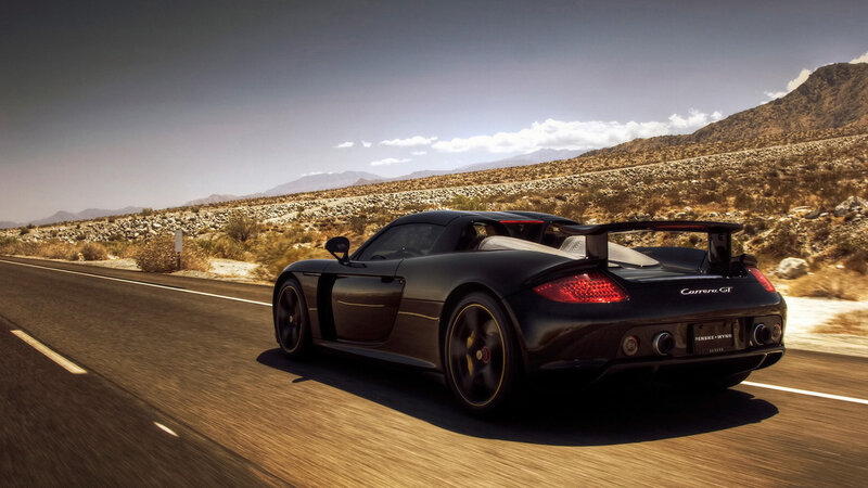 Black sports car on desert road